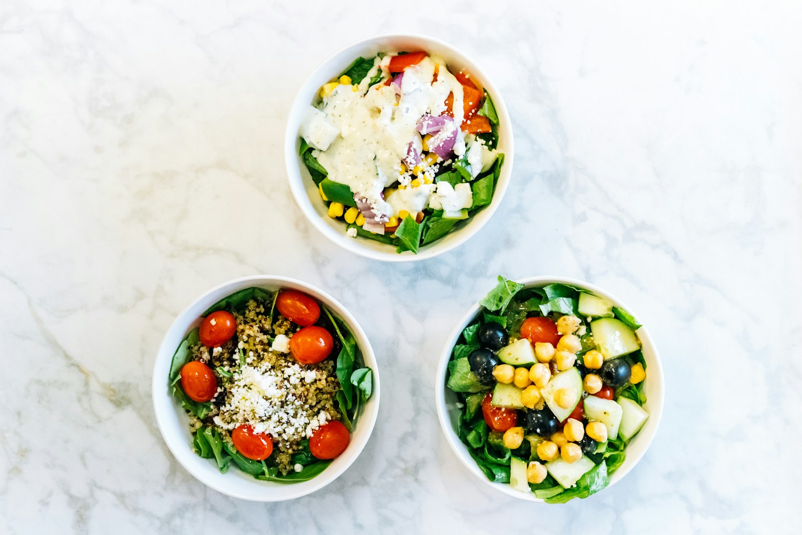 Fresh Mediterranean salads with grains, vegetables, and feta